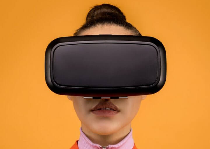 woman in a long sleeve shirt wearing black vr goggles